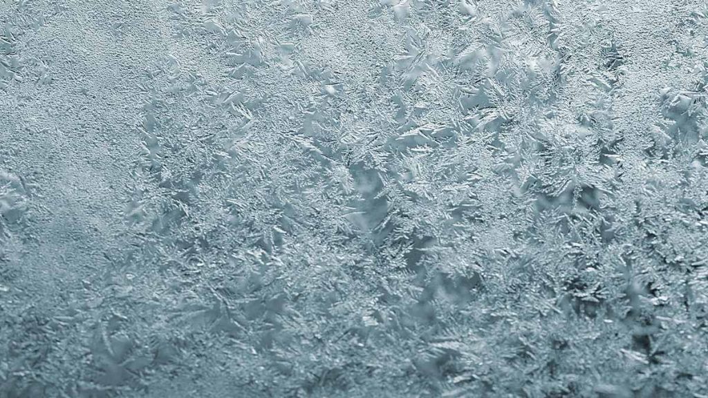 Frost on window glass, where a plant sitting too close can meet air far colder than the room overnight